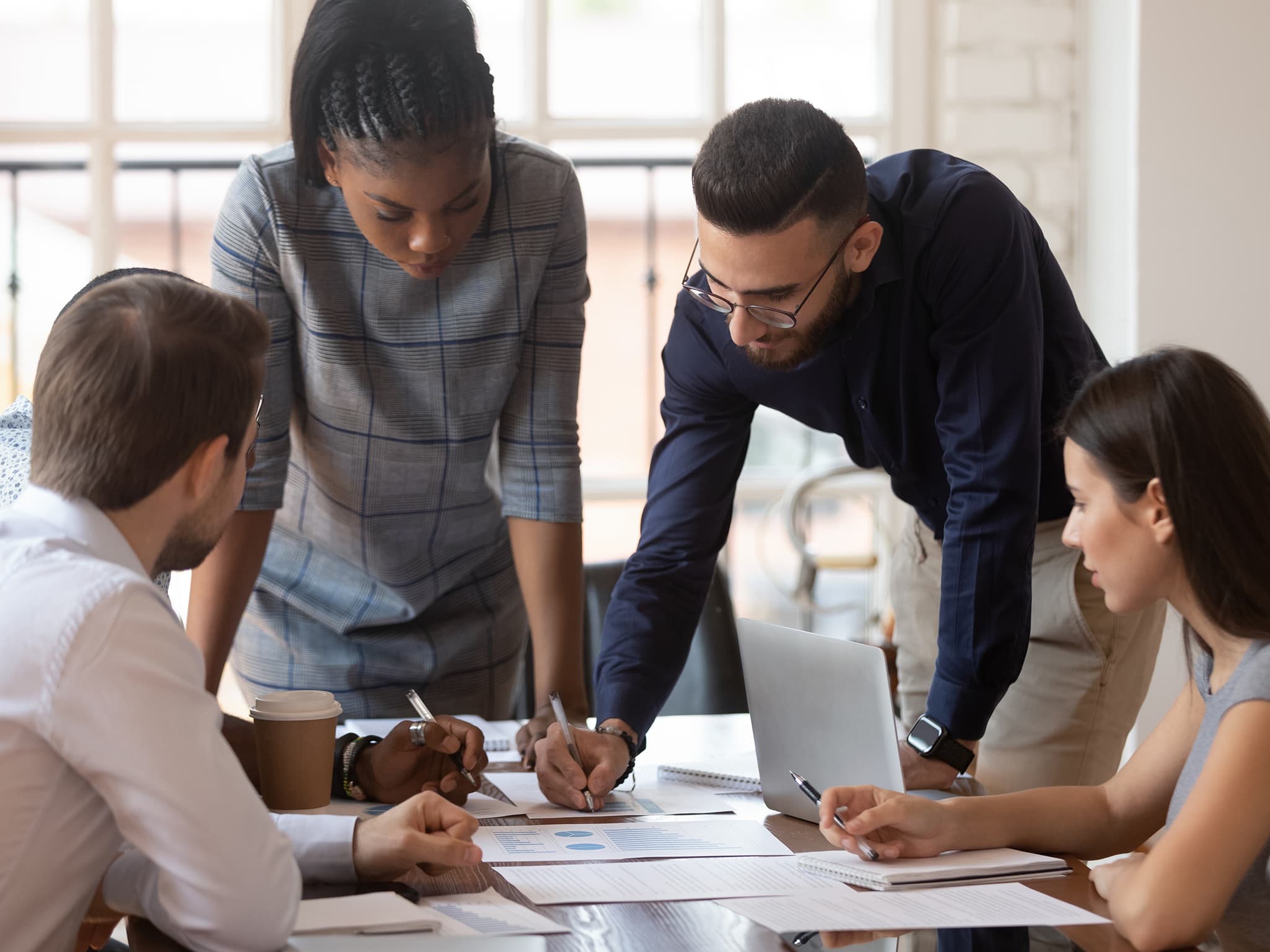 Staff around desk in discussions